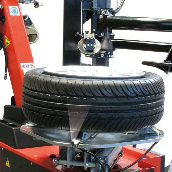 Quick inflation valve for tubeless tires. Pedal-operated inflation device complete with inflator valve and pressure gauge.