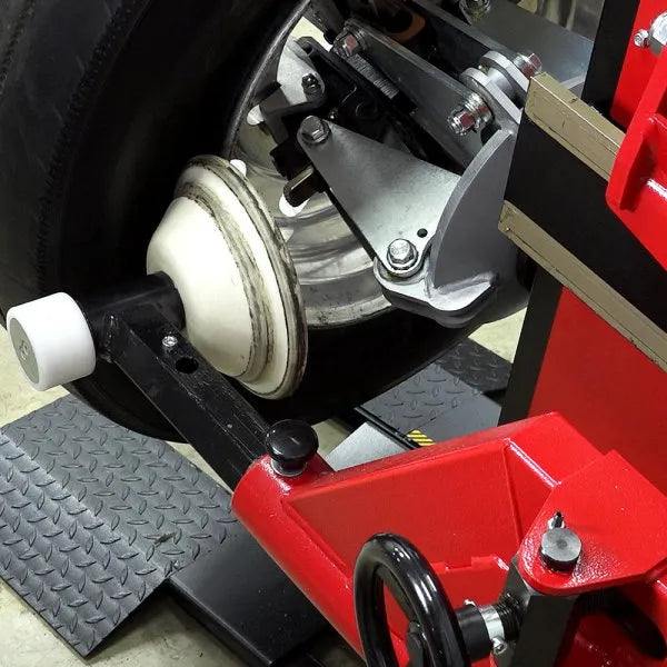Adjustable arm positioning allows easy movement of bead breaker to lower drop center in front of the tire.
